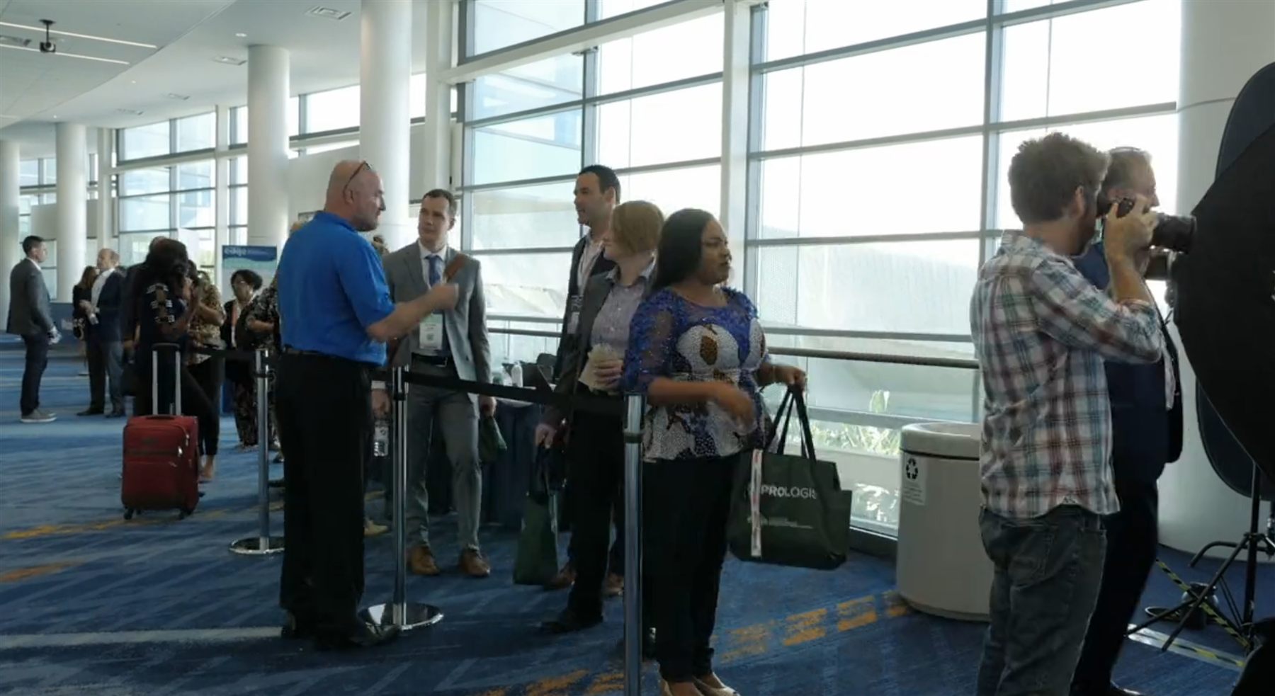 Steady line of conference attendees at a headshot lounge booth activation