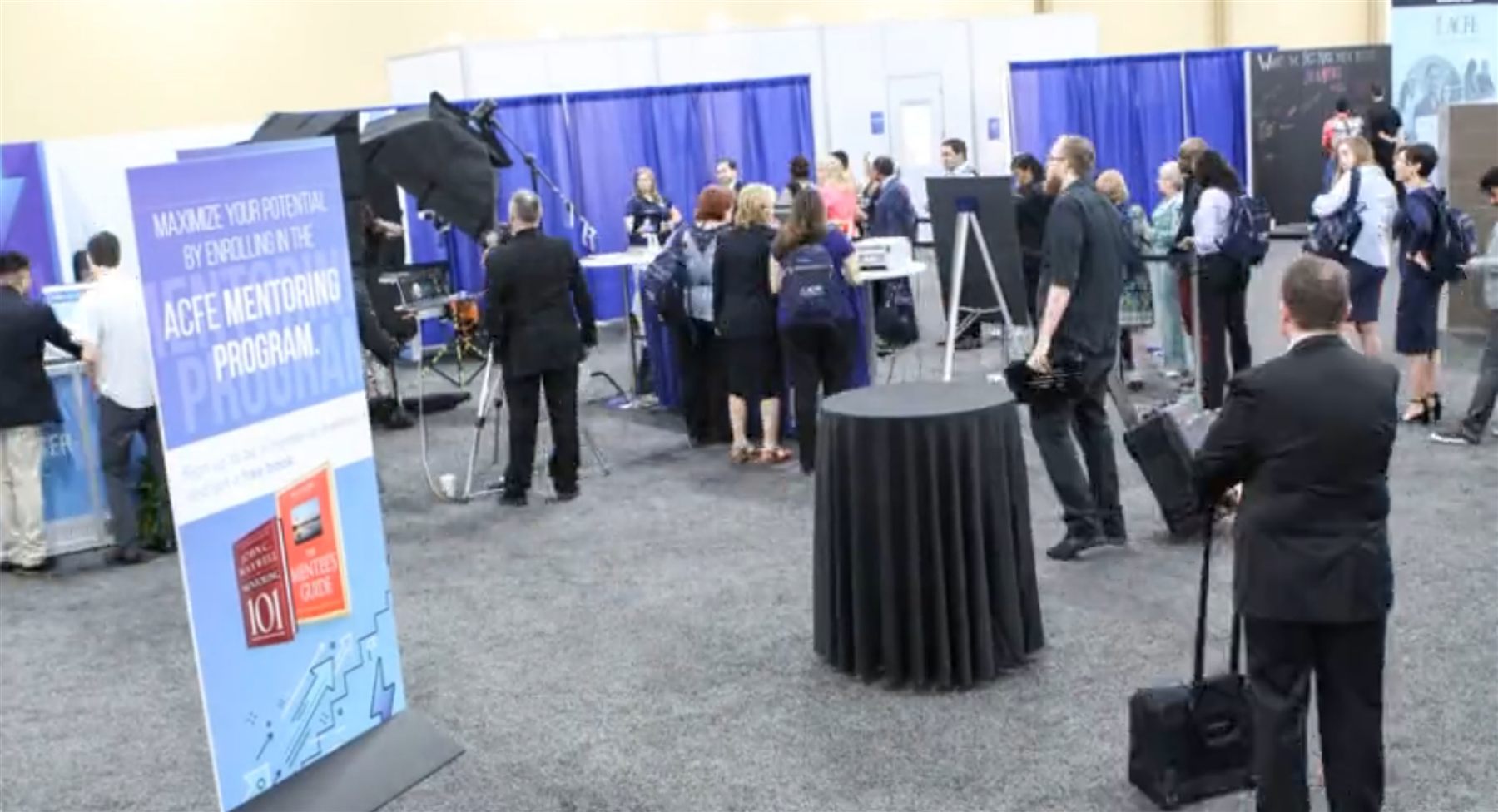 Full trade show headshot lounge activation setup — lighting, backdrop, and attendees