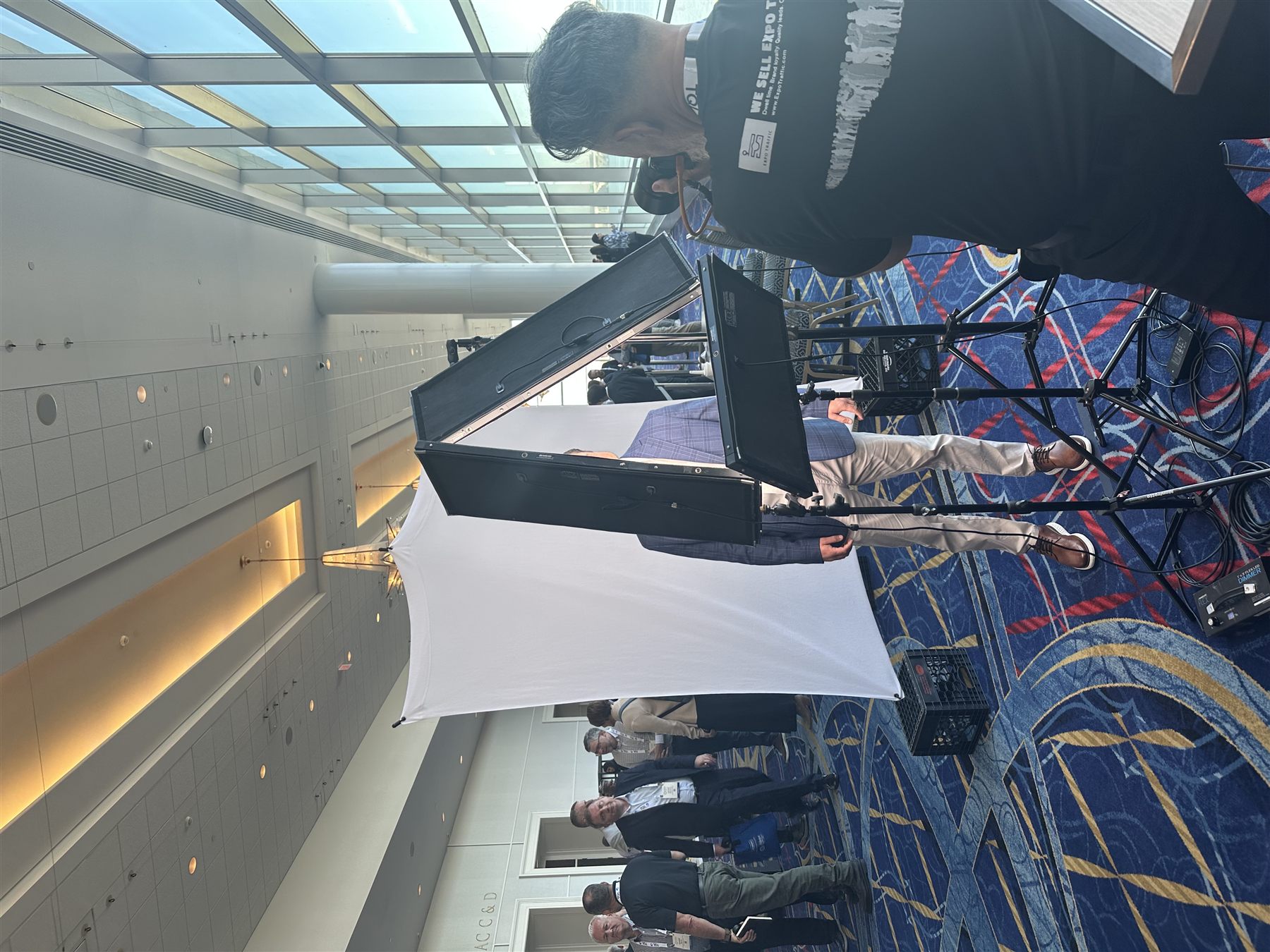 Behind the scenes — studio lighting rig and backdrop setup at a corporate venue