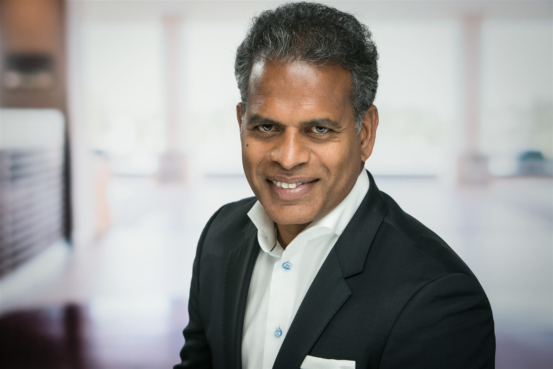 Professional corporate headshot — studio-quality lighting on-site at a corporate office