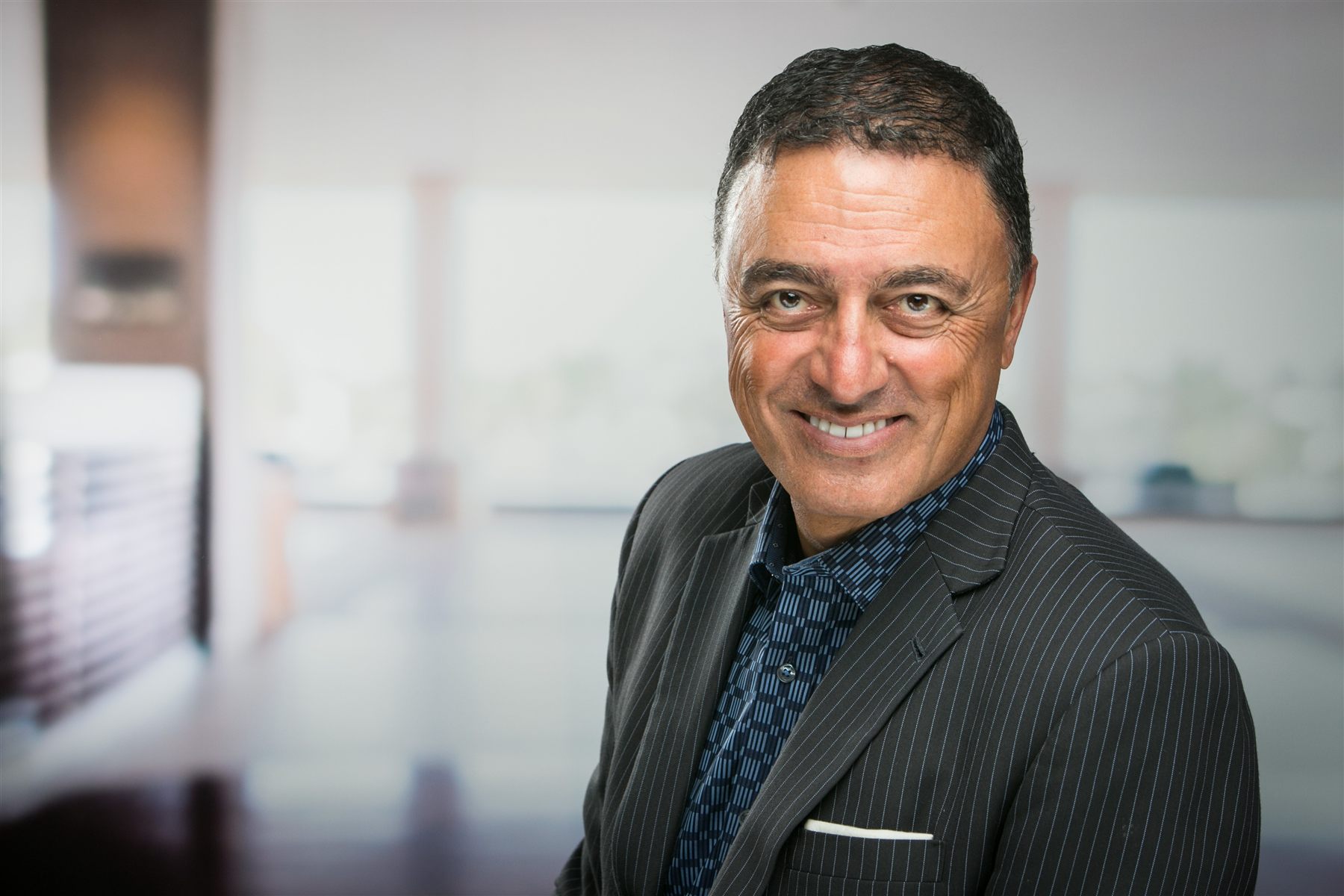 Team headshot session — consistent framing with clean solid-color backdrop