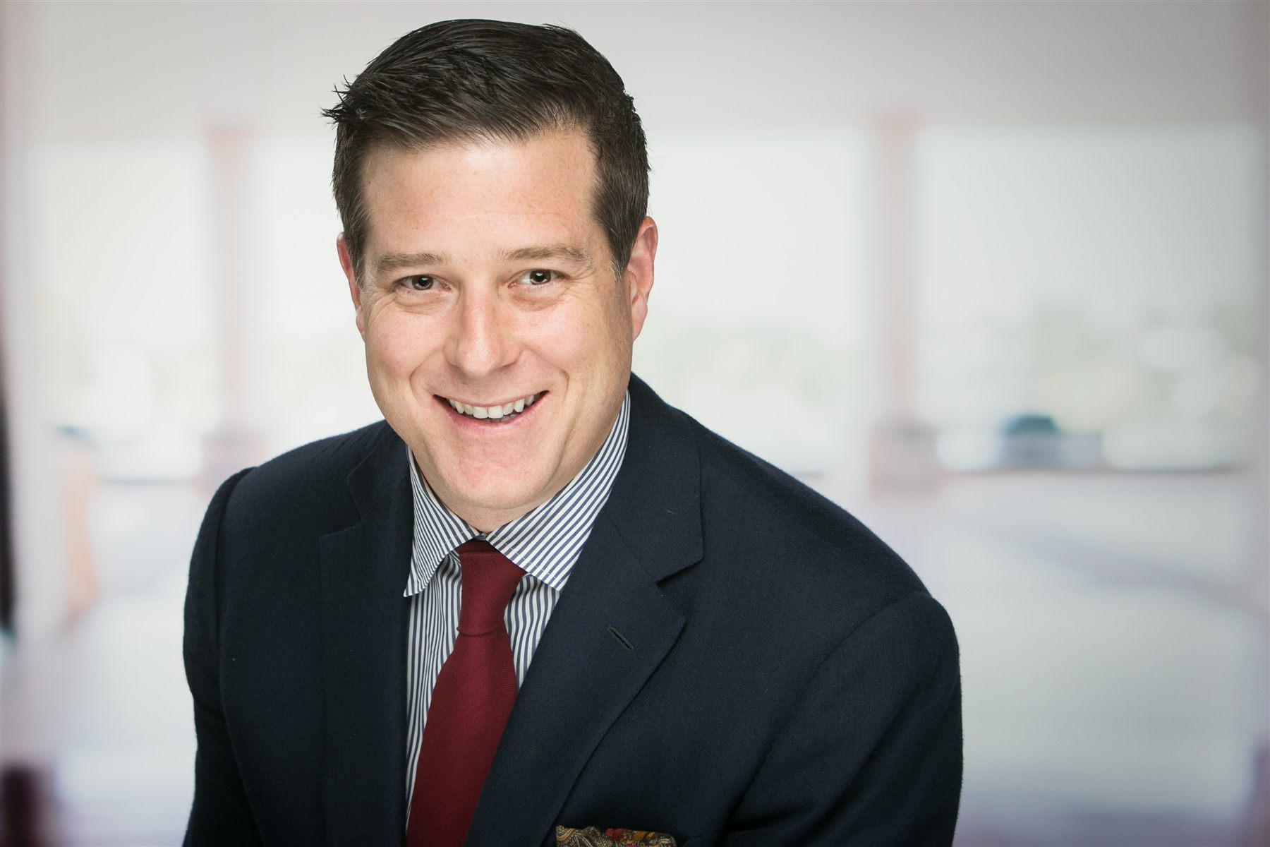 Executive headshot on a clean backdrop at a major technology conference