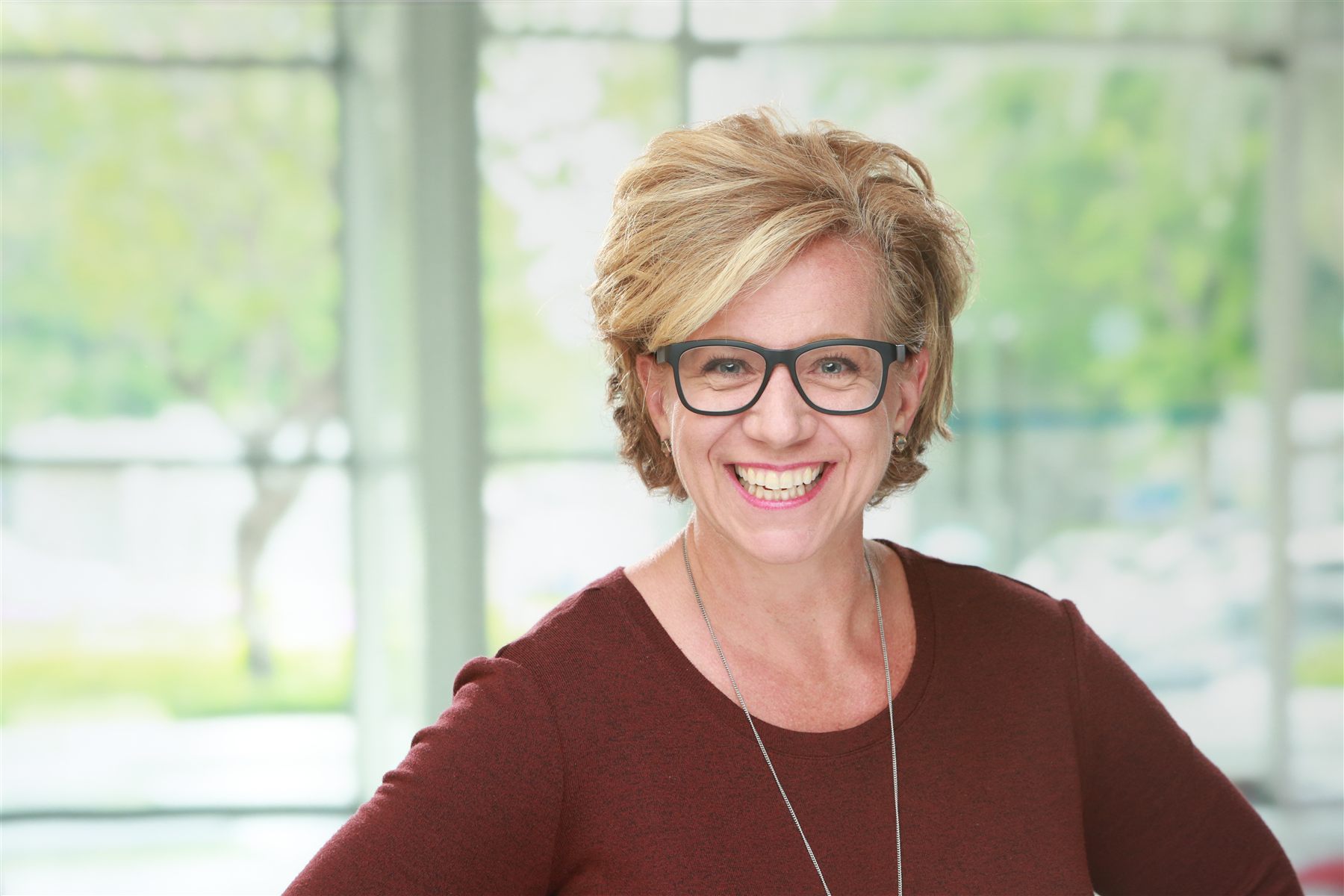 Team headshot at a sales kickoff event — clean solid-color backdrop