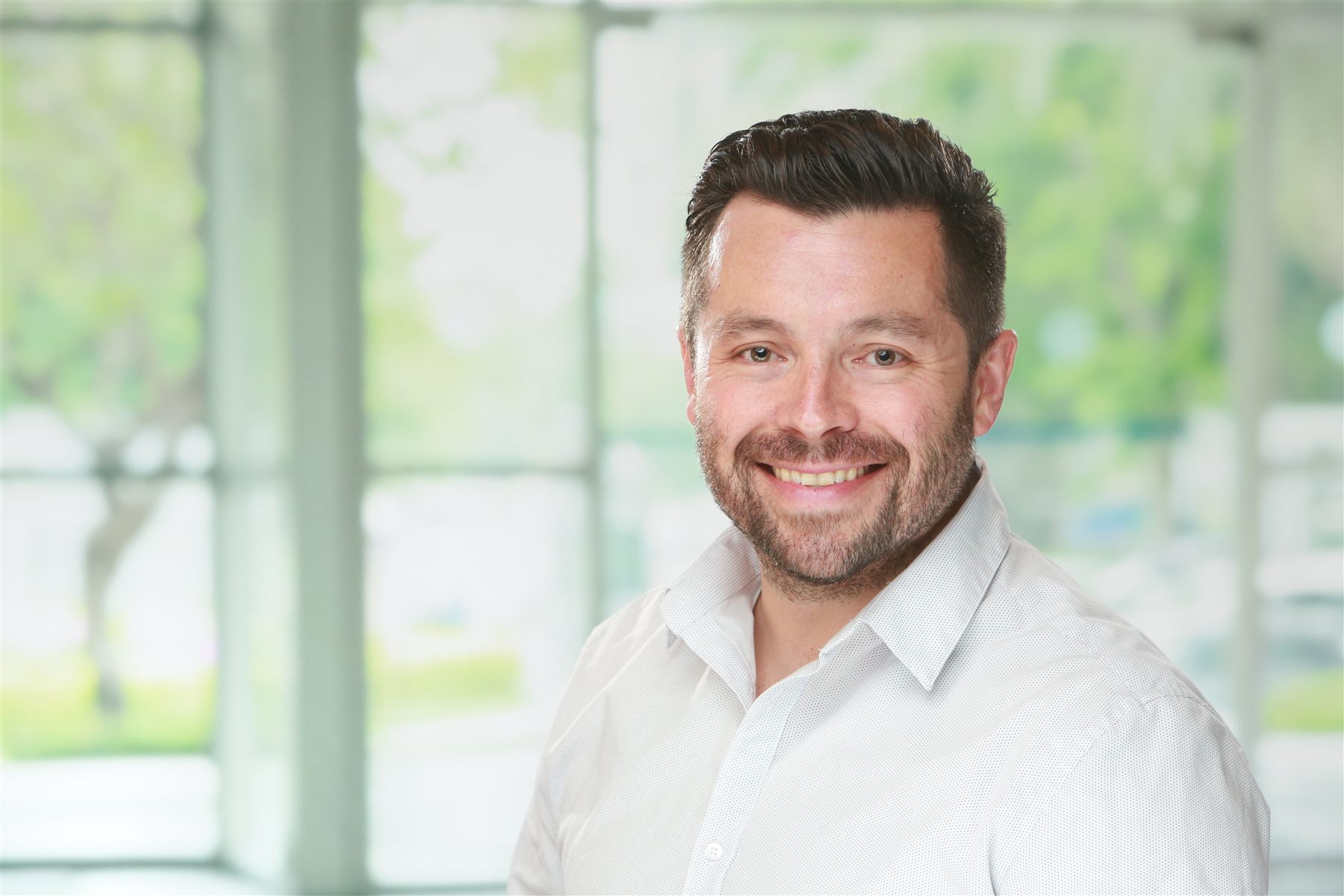 Corporate headshot — professional in-office session with studio lighting